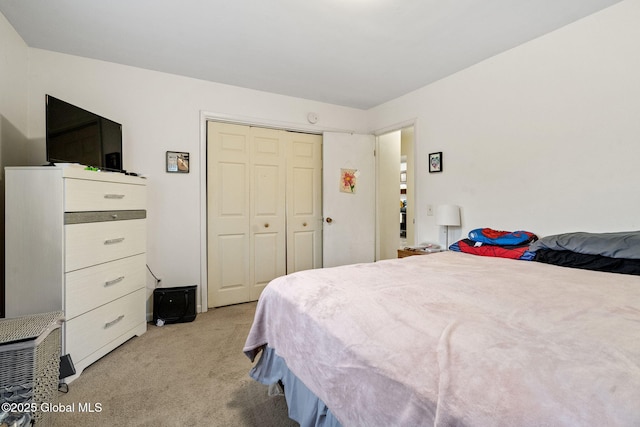 bedroom featuring light colored carpet and a closet