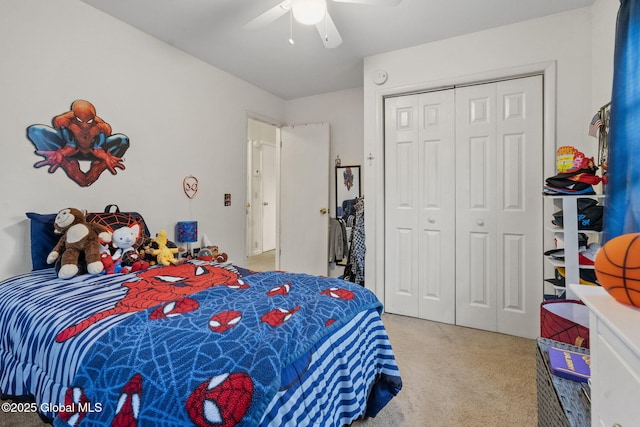 bedroom with light colored carpet, ceiling fan, and a closet