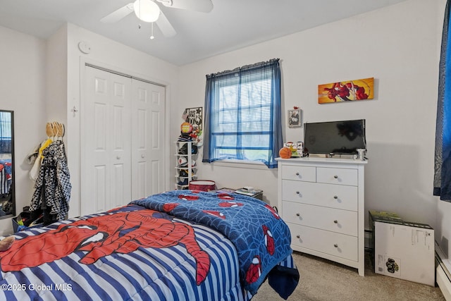 bedroom with a ceiling fan, light carpet, and a closet