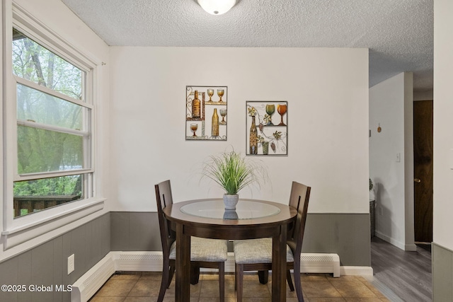 dining space with baseboards and a textured ceiling
