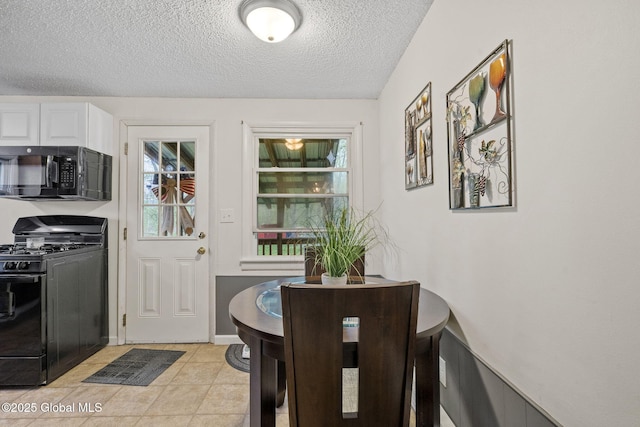 interior space featuring a textured ceiling and light tile patterned floors