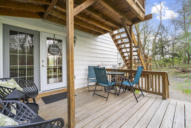 deck with stairs and outdoor dining space