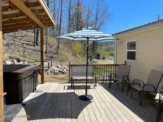 wooden deck with a hot tub