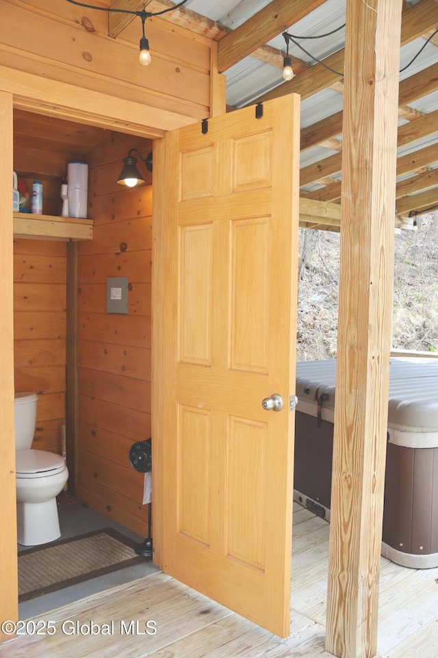 bathroom with toilet and wood finished floors
