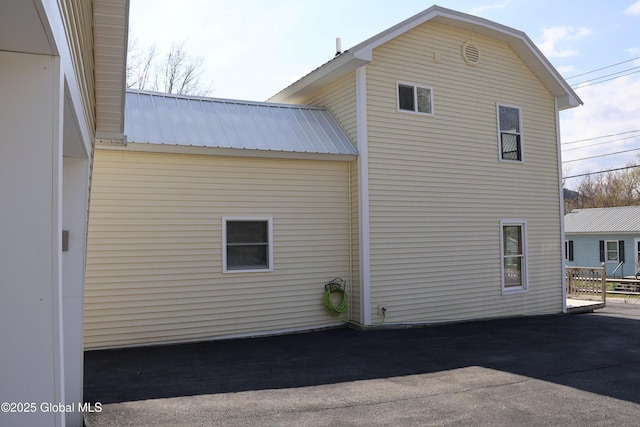 view of side of home with metal roof
