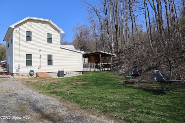 view of property exterior featuring a lawn and central air condition unit