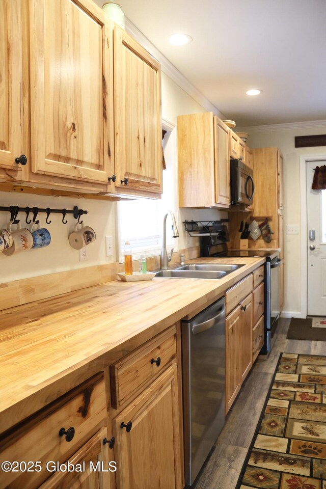 kitchen featuring stainless steel dishwasher, butcher block countertops, a sink, black microwave, and crown molding