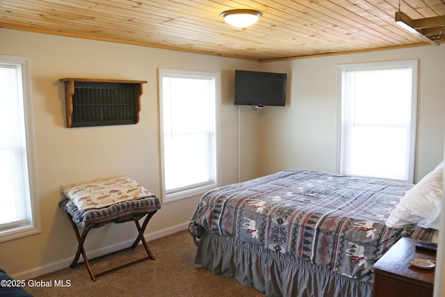 bedroom featuring carpet floors, baseboards, and wooden ceiling