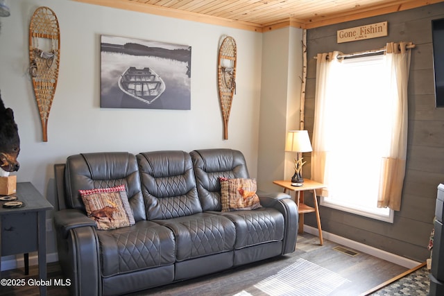 living area featuring wood ceiling, wood finished floors, and visible vents
