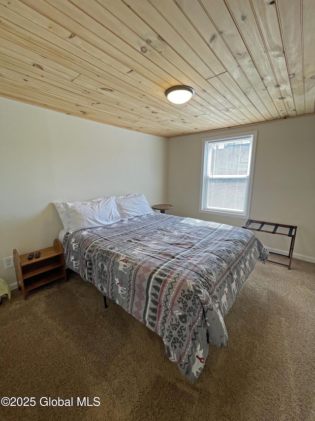 bedroom with carpet, baseboards, and wooden ceiling
