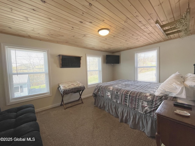 bedroom featuring carpet flooring, baseboards, and wood ceiling