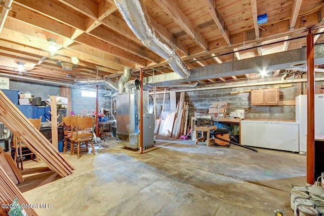 below grade area featuring heating unit and concrete block wall