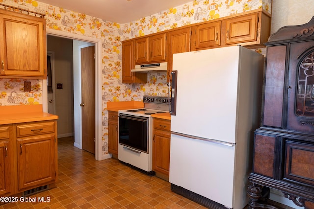 19 Centennial Dr, Queensbury, NY 12804 - kitchen with white appliances, wallpapered walls, under cabinet range hood, light countertops, and light flooring