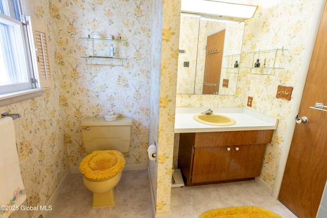 19 Centennial Dr, Queensbury, NY 12804 - bathroom featuring vanity, toilet, baseboards, and wallpapered walls