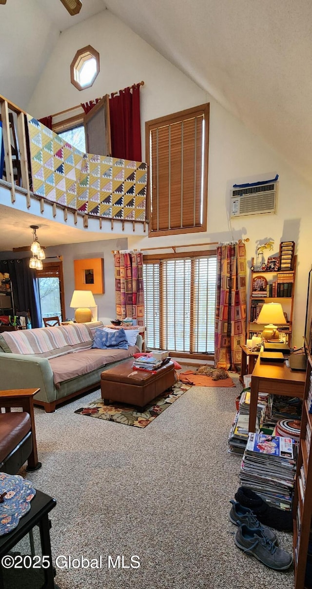 carpeted living area featuring a chandelier, high vaulted ceiling, and a wall unit AC