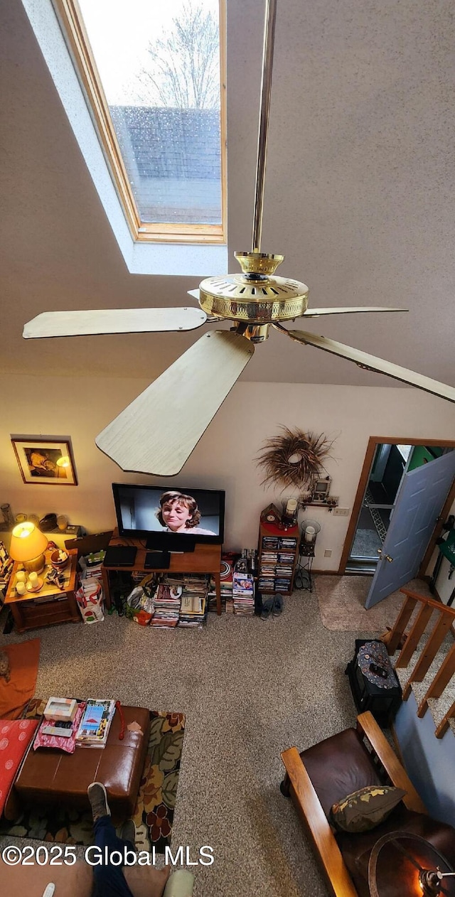carpeted living room featuring stairs and a skylight