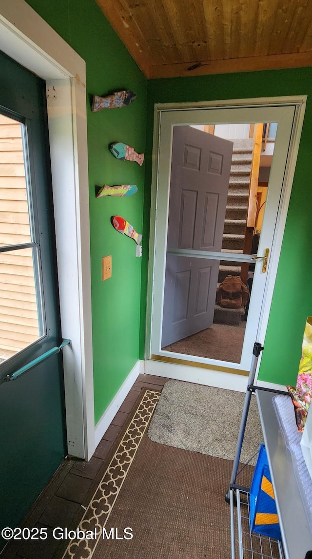entryway with baseboards and wooden ceiling