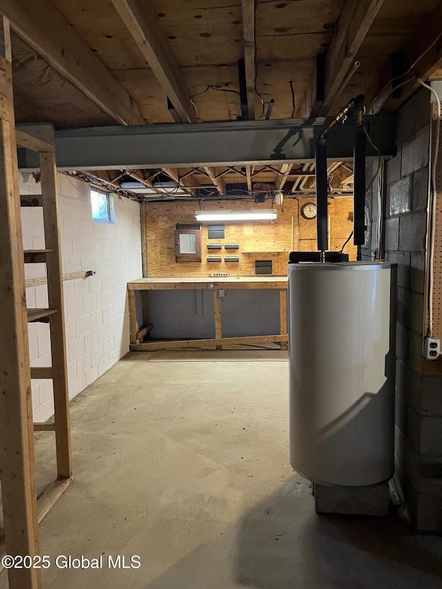 below grade area featuring water heater and a workshop area