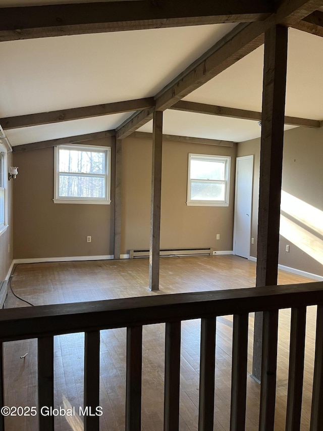 bonus room featuring baseboards, vaulted ceiling with beams, a baseboard radiator, and hardwood / wood-style flooring