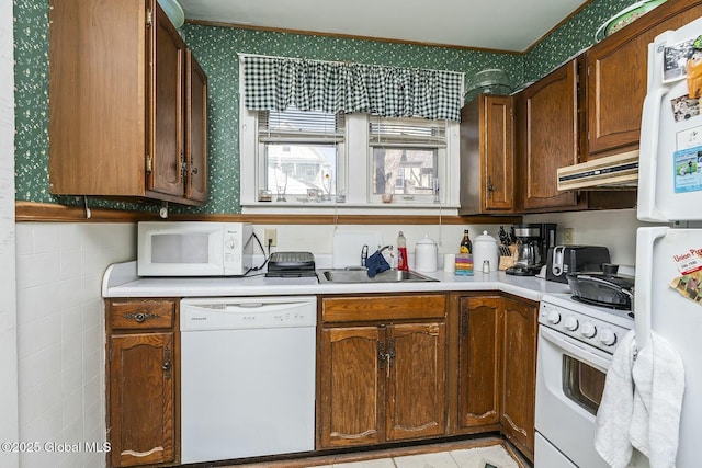 1261-1263 The Plz, Schenectady, NY 12308 - kitchen with white appliances, wallpapered walls, a sink, under cabinet range hood, and light countertops