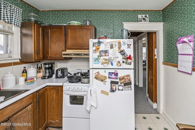 1261-1263 The Plz, Schenectady, NY 12308 - kitchen with white appliances, under cabinet range hood, wallpapered walls, ornamental molding, and light countertops