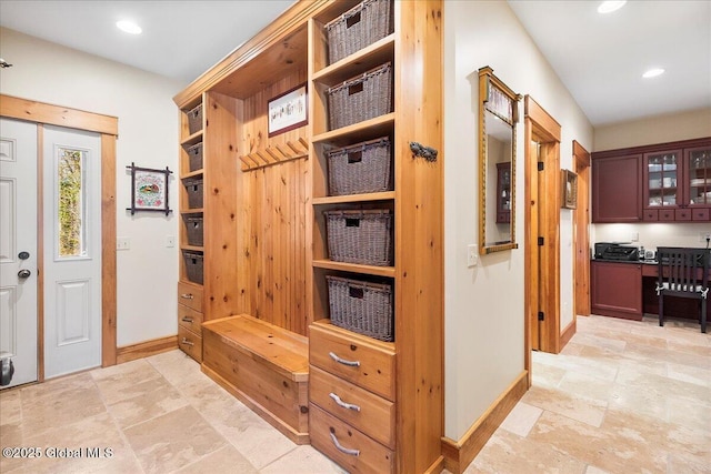 mudroom with baseboards, stone finish floor, and recessed lighting