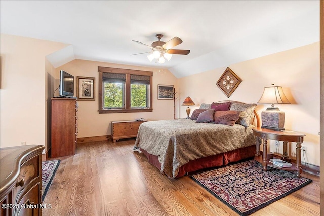 bedroom featuring vaulted ceiling, ceiling fan, baseboards, and wood finished floors