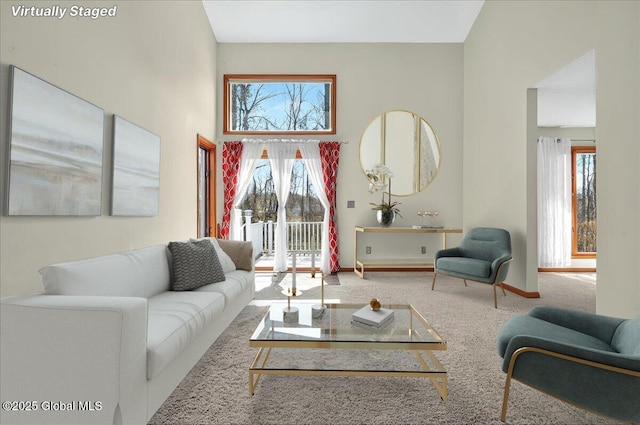 carpeted living area with baseboards