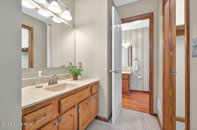 bathroom with baseboards and vanity
