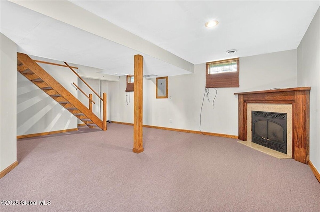 unfurnished living room featuring baseboards, electric panel, carpet flooring, and stairs