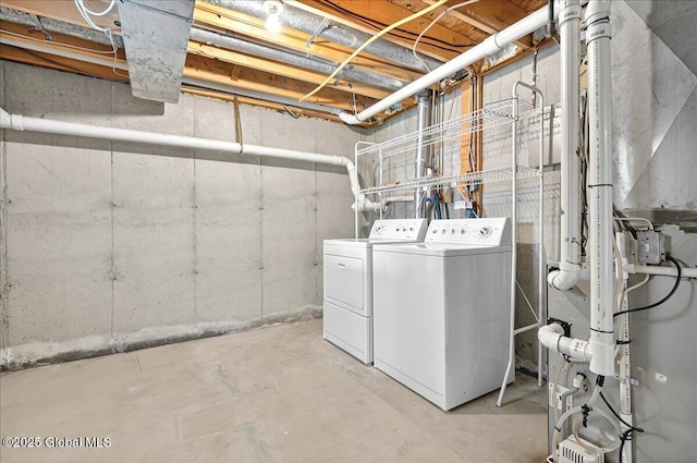 clothes washing area featuring independent washer and dryer and laundry area