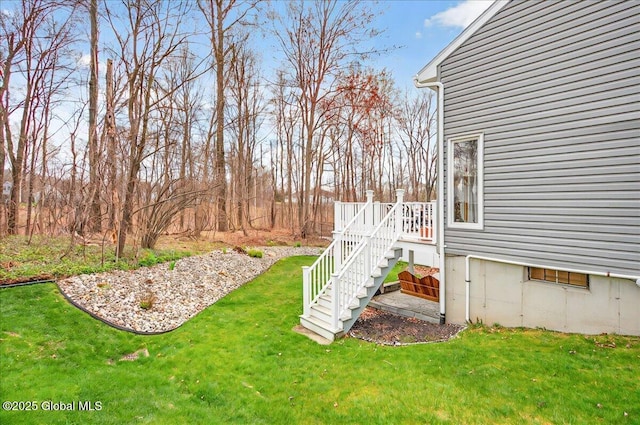 view of yard featuring a deck and stairs