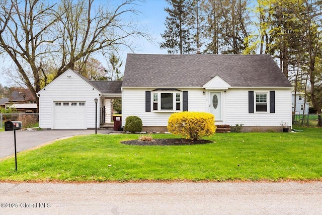 new england style home with fence, a shingled roof, an attached garage, a front lawn, and driveway