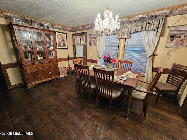 dining room featuring an inviting chandelier, a textured ceiling, dark wood-style flooring, and crown molding