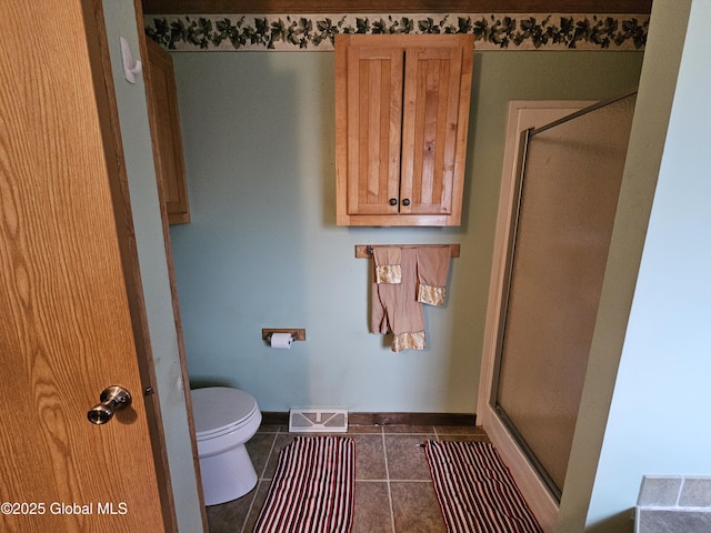 bathroom featuring tile patterned floors, a shower stall, toilet, baseboards, and visible vents