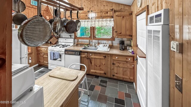 185 Old Schroon Rd, Schroon, NY 12870 - kitchen featuring a sink, a heating unit, wooden walls, vaulted ceiling, and white appliances