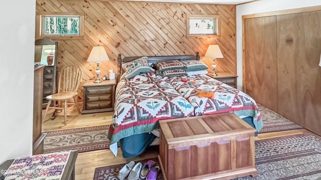 185 Old Schroon Rd, Schroon, NY 12870 - bedroom with wooden walls, a closet, and hardwood / wood-style floors