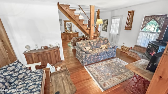 185 Old Schroon Rd, Schroon, NY 12870 - living room featuring a wood stove, wood finished floors, and stairway