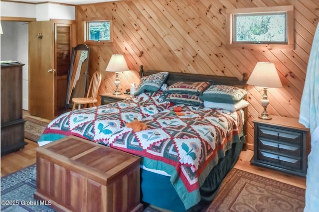 185 Old Schroon Rd, Schroon, NY 12870 - bedroom featuring wood walls, wood finished floors, and multiple windows