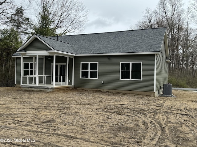2 Birch Dr, Moreau, NY 12828 - back of property featuring a shingled roof and central AC unit