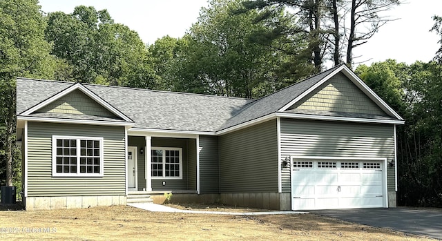 2 Birch Dr, Moreau, NY 12828 - view of front of home featuring asphalt driveway, an attached garage, and roof with shingles