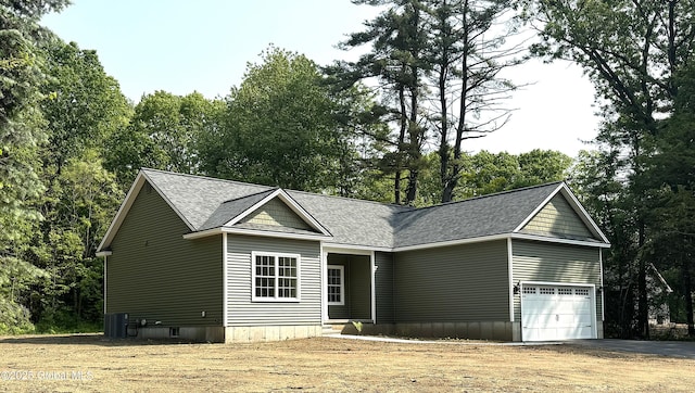 2 Birch Dr, Moreau, NY 12828 - view of front of home featuring driveway, a shingled roof, an attached garage, and view of scattered trees