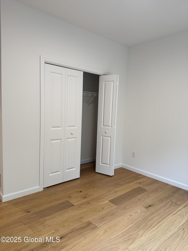 2 Birch Dr, Moreau, NY 12828 - unfurnished bedroom featuring a closet and light wood-type flooring