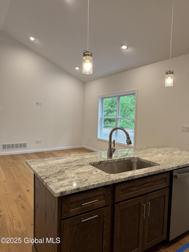 2 Birch Dr, Moreau, NY 12828 - kitchen with stainless steel dishwasher, light wood-style flooring, decorative light fixtures, light stone counters, and recessed lighting