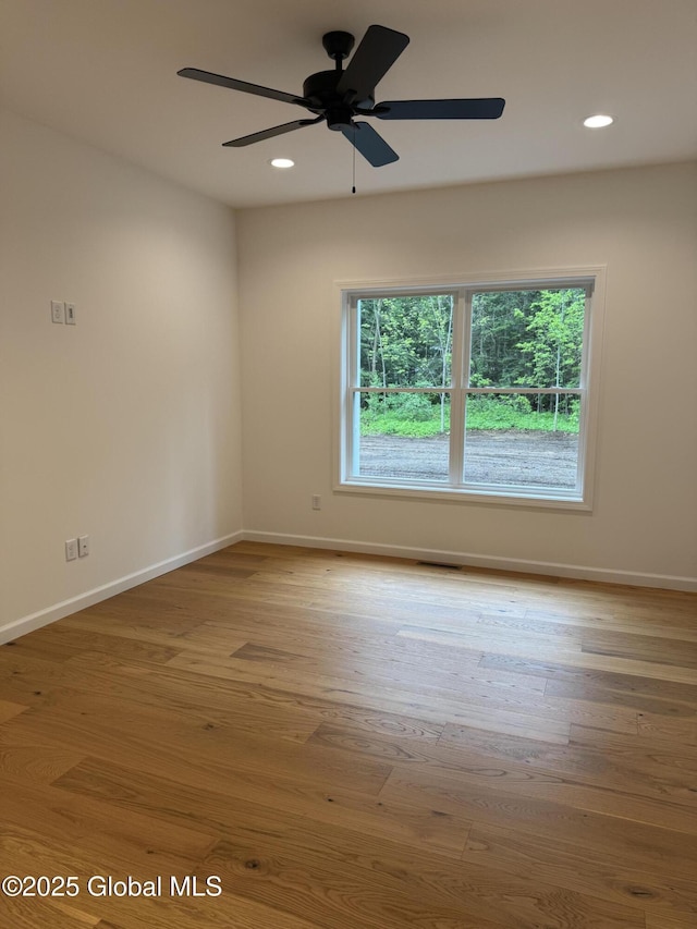 2 Birch Dr, Moreau, NY 12828 - empty room featuring plenty of natural light, wood finished floors, ceiling fan, and recessed lighting