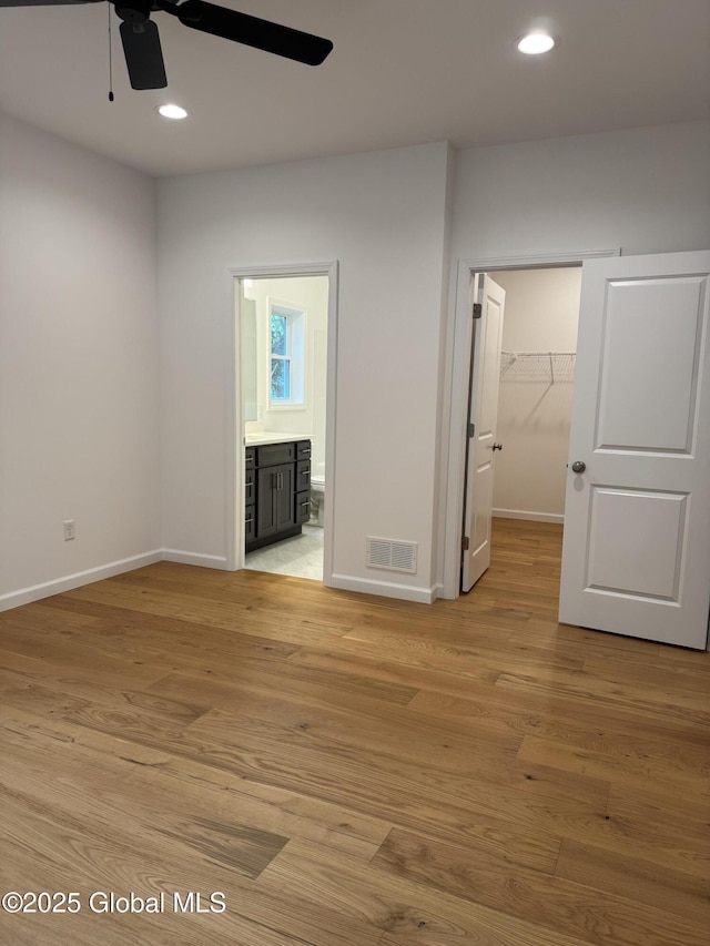 2 Birch Dr, Moreau, NY 12828 - unfurnished bedroom with light wood-style flooring, a spacious closet, ensuite bathroom, recessed lighting, and a closet