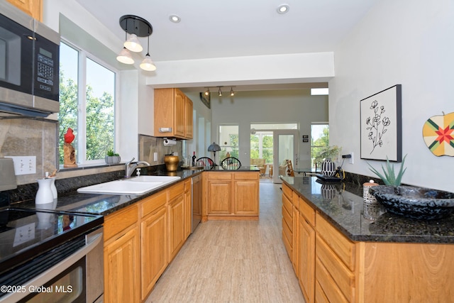 107 Wilderness Way, Stephentown, NY 12169 - kitchen with appliances with stainless steel finishes, light wood finished floors, dark stone counters, tasteful backsplash, and recessed lighting