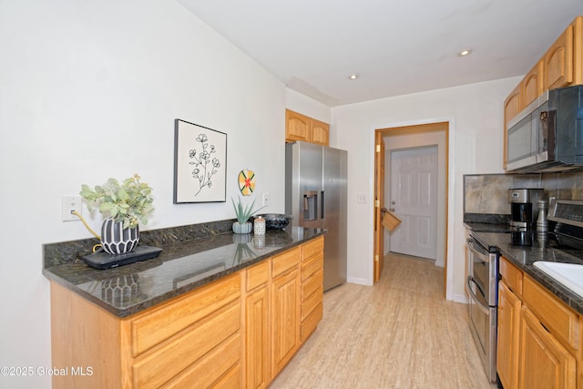 107 Wilderness Way, Stephentown, NY 12169 - kitchen featuring stainless steel appliances, light wood-style floors, dark stone counters, and recessed lighting