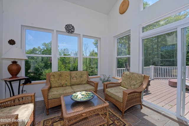 107 Wilderness Way, Stephentown, NY 12169 - sunroom featuring high vaulted ceiling, stone tile flooring, and a deck