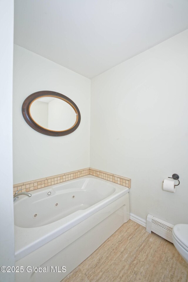 107 Wilderness Way, Stephentown, NY 12169 - bathroom with a baseboard radiator, a jetted tub, and wood finished floors